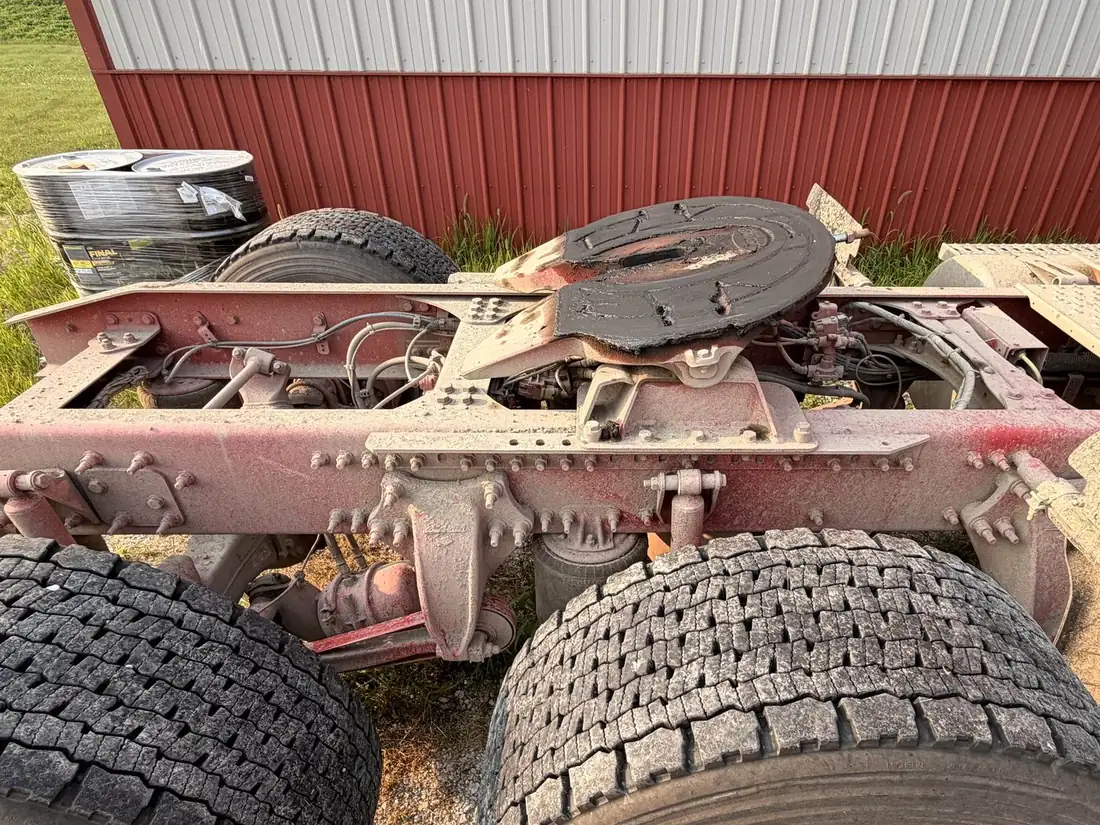 Dust-caked truck frame and fifth wheel before degreasing