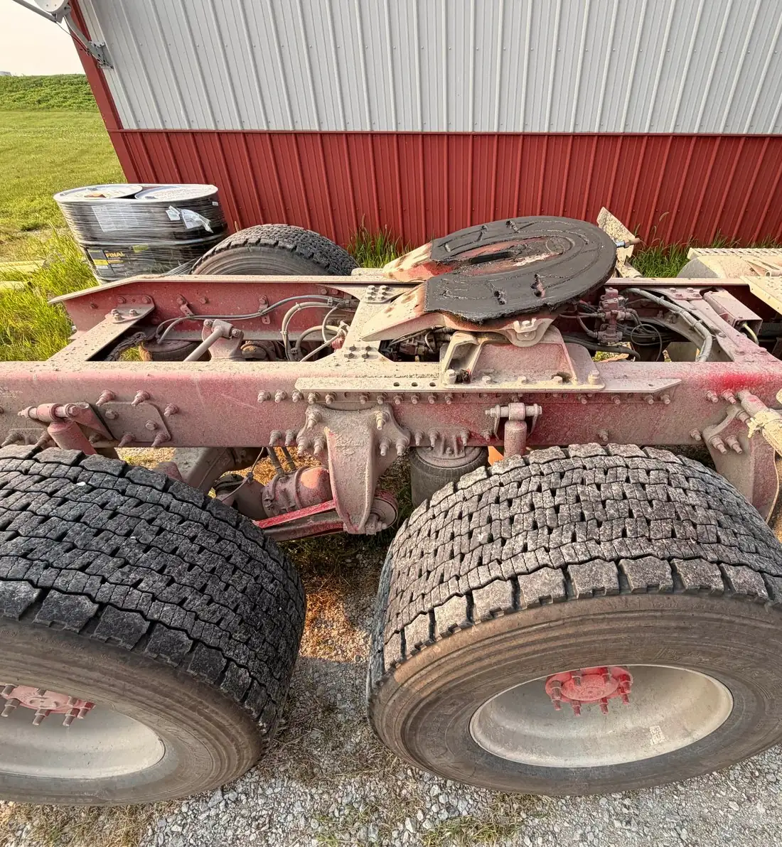 Dust-caked truck frame and fifth wheel before degreasing