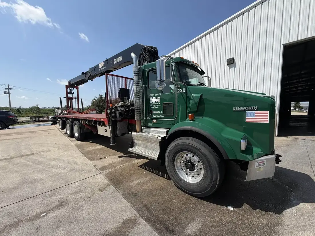 Green boom crane truck washed on site by Heartland Fleet Cleaning