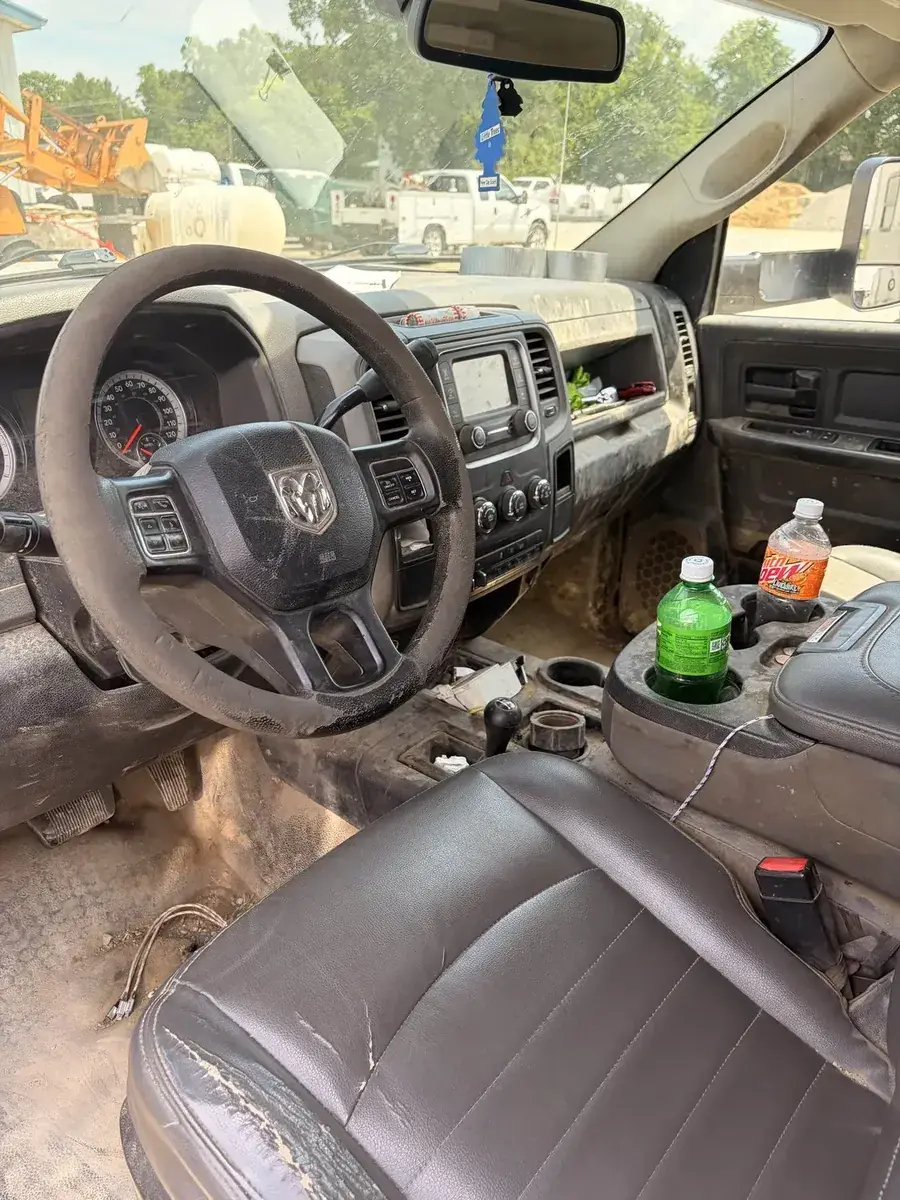 Truck cab interior before cleaning — clutter and debris